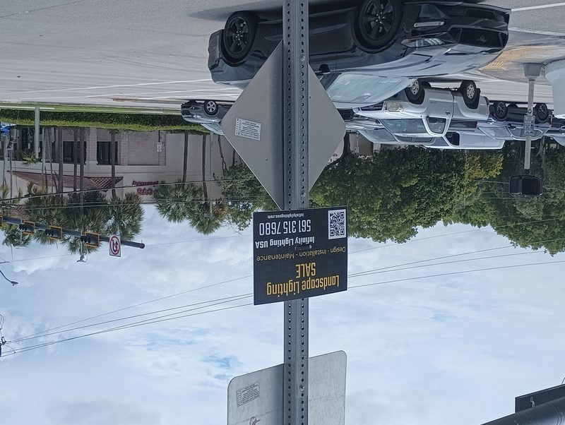 Landscape lighting bandit sign on utility pole in Cooper City Florida